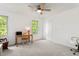 Bright bedroom featuring neutral carpet, a ceiling fan, a writing desk, and natural light from two windows at 874 Mercury Cir, Lone Tree, CO 80124