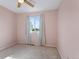 Light-filled bedroom with pink walls, carpet, and a large window offering natural light at 874 Mercury Cir, Lone Tree, CO 80124