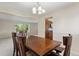 Well-lit dining room with a dark wood table set and view into the living room at 874 Mercury Cir, Lone Tree, CO 80124