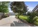 Long driveway leading to a two-car garage with mature landscaping and well-maintained lawn at 874 Mercury Cir, Lone Tree, CO 80124
