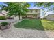 Charming two-story home featuring a well-kept lawn and rock landscaping at 874 Mercury Cir, Lone Tree, CO 80124