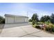 Detached two-car garage with extra parking and landscaping features creates backyard interest at 874 Mercury Cir, Lone Tree, CO 80124