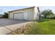 Two-car garage with an extra-wide driveway and side door at 874 Mercury Cir, Lone Tree, CO 80124
