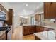 Open kitchen with granite countertops and stainless steel appliances adjacent to a brick fireplace at 874 Mercury Cir, Lone Tree, CO 80124