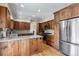 Spacious kitchen with stainless steel appliances, granite countertops, and wood cabinets at 874 Mercury Cir, Lone Tree, CO 80124