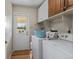 Convenient laundry room with washer, dryer, upper cabinets, and exterior access at 874 Mercury Cir, Lone Tree, CO 80124
