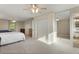 Spacious and bright carpeted main bedroom with ceiling fans, ensuite bath, and two closets at 874 Mercury Cir, Lone Tree, CO 80124