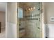 Tiled walk-in shower featuring a glass door and a built-in bench at 874 Mercury Cir, Lone Tree, CO 80124