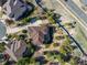 Aerial view of luxury home with landscaped yard, patio, and surrounding greenery in a desirable neighborhood at 20148 E Windy Pine Pl, Parker, CO 80134