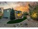 Expansive backyard at twilight with lush lawn, stone accents, fire pit, and mature landscaping, perfect for outdoor living at 20148 E Windy Pine Pl, Parker, CO 80134