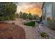 Serene backyard features a stone pathway, mature trees, tiered garden beds, and a relaxing outdoor seating area at 20148 E Windy Pine Pl, Parker, CO 80134