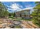 Landscaped backyard with stone water feature and an expansive patio area at 20148 E Windy Pine Pl, Parker, CO 80134