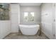 Bright bathroom features a standalone tub with paneled walls and natural light at 20148 E Windy Pine Pl, Parker, CO 80134