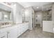 Bright bathroom features dual sinks, granite counters, and walk-in shower at 20148 E Windy Pine Pl, Parker, CO 80134