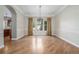Formal dining room boasts hardwood floors, large windows, and stylish chandelier at 20148 E Windy Pine Pl, Parker, CO 80134