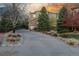 Inviting home with a long driveway, lush greenery, and beautiful stone accents at 20148 E Windy Pine Pl, Parker, CO 80134
