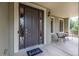 Welcoming front porch with seating next to an elegant door and side windows at 20148 E Windy Pine Pl, Parker, CO 80134