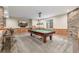 Carpeted game room with pool table, wood paneling, and stone accent wall at 20148 E Windy Pine Pl, Parker, CO 80134