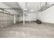 Spacious three car garage with epoxy flooring and storage racks provides ample space for vehicles and storage at 20148 E Windy Pine Pl, Parker, CO 80134