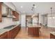 Open kitchen with granite counters, stainless steel appliances, and hardwood floors at 20148 E Windy Pine Pl, Parker, CO 80134