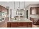 Spacious kitchen island features granite counters, seating, and modern lighting at 20148 E Windy Pine Pl, Parker, CO 80134