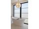 Elegant bathroom showcasing a freestanding tub with black trim windows and a modern pendant light at 821 S York St, Denver, CO 80209