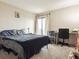 Bedroom featuring a comfortable bed, large window with curtains and a study desk at 480 S Marion Pkwy # 901, Denver, CO 80209