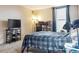 This bedroom features a large window and a well-lit study area with multiple monitors at 480 S Marion Pkwy # 901, Denver, CO 80209
