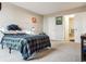 A well-lit bedroom features a comfortable bed and an adjacent bathroom with an open doorway at 480 S Marion Pkwy # 901, Denver, CO 80209