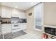 Efficient kitchen with white cabinetry and tile backsplash at 480 S Marion Pkwy # 901, Denver, CO 80209