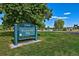 Sign for Denver's Washington Park set against the backdrop of lush greenery and a lake at 480 S Marion Pkwy # 901, Denver, CO 80209