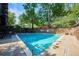 Outdoor swimming pool surrounded by lush greenery and lounge chairs at 480 S Marion Pkwy # 901, Denver, CO 80209