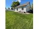 Well-maintained backyard featuring lush green lawn and white picket fence, ideal for outdoor activities at 5010 Golden Eagle Pkwy, Brighton, CO 80601