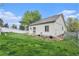 A well-maintained backyard with a white fence surrounding the property, and green grass at 5010 Golden Eagle Pkwy, Brighton, CO 80601