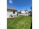 Spacious backyard with a well-kept lawn and wooden fence, providing a private outdoor space at 5010 Golden Eagle Pkwy, Brighton, CO 80601