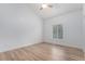Bright bedroom with wood floors, high ceilings, and large window at 5010 Golden Eagle Pkwy, Brighton, CO 80601