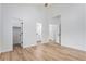 Bright bedroom boasts wood-look flooring, neutral paint, and en suite bathroom access at 5010 Golden Eagle Pkwy, Brighton, CO 80601