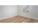 A bright bedroom with wood floors and a window providing natural light at 5010 Golden Eagle Pkwy, Brighton, CO 80601
