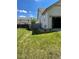 Spacious backyard with a well-maintained lawn, garage, and wooden fence surrounding the area at 5010 Golden Eagle Pkwy, Brighton, CO 80601