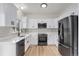 Modern kitchen featuring white cabinets, stainless steel appliances, and subway tile backsplash at 5010 Golden Eagle Pkwy, Brighton, CO 80601
