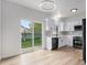 Bright kitchen with backyard access, featuring white cabinets and modern appliances at 5010 Golden Eagle Pkwy, Brighton, CO 80601