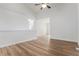 Light filled living room with hard wood floors, neutral paint, and view to hallway and other living areas at 5010 Golden Eagle Pkwy, Brighton, CO 80601