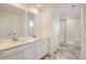 Elegant bathroom with double vanity, modern shower, and stylish marble tile flooring at 7260 Waterleaf Trl, Littleton, CO 80125