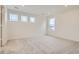 Bright bedroom with neutral carpet, three windows, and fresh paint, ready for personalization at 7260 Waterleaf Trl, Littleton, CO 80125