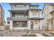Contemporary two-story home with a covered porch and balcony, showcasing modern design and curb appeal at 7260 Waterleaf Trl, Littleton, CO 80125