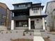 Modern two-story home boasting mixed siding, a covered porch, and professional landscaping at 7260 Waterleaf Trl, Littleton, CO 80125