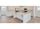 Bright kitchen featuring a large island, stainless steel appliances, and white cabinets for a modern feel at 7260 Waterleaf Trl, Littleton, CO 80125