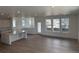 Bright, open-concept living room featuring hardwood floors, recessed lighting, and large windows at 7260 Waterleaf Trl, Littleton, CO 80125