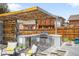 Outdoor kitchen with stainless steel grill, beverage cooler, and custom pergola at 822 Poplar St, Denver, CO 80220