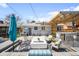 Backyard with custom pergola, outdoor kitchen, composite deck, and fire pit seating area at 822 Poplar St, Denver, CO 80220